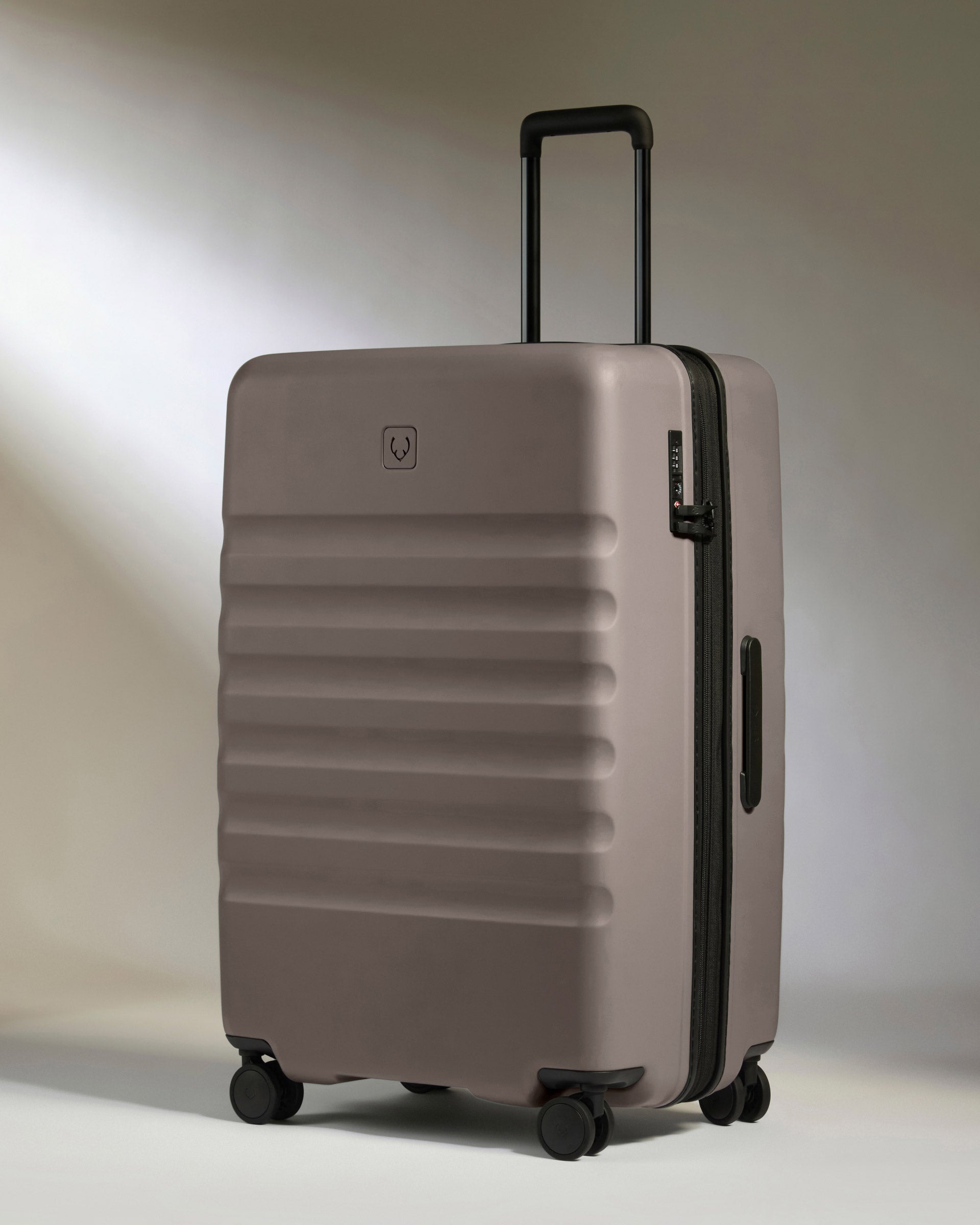 a grey suitcase with wheels