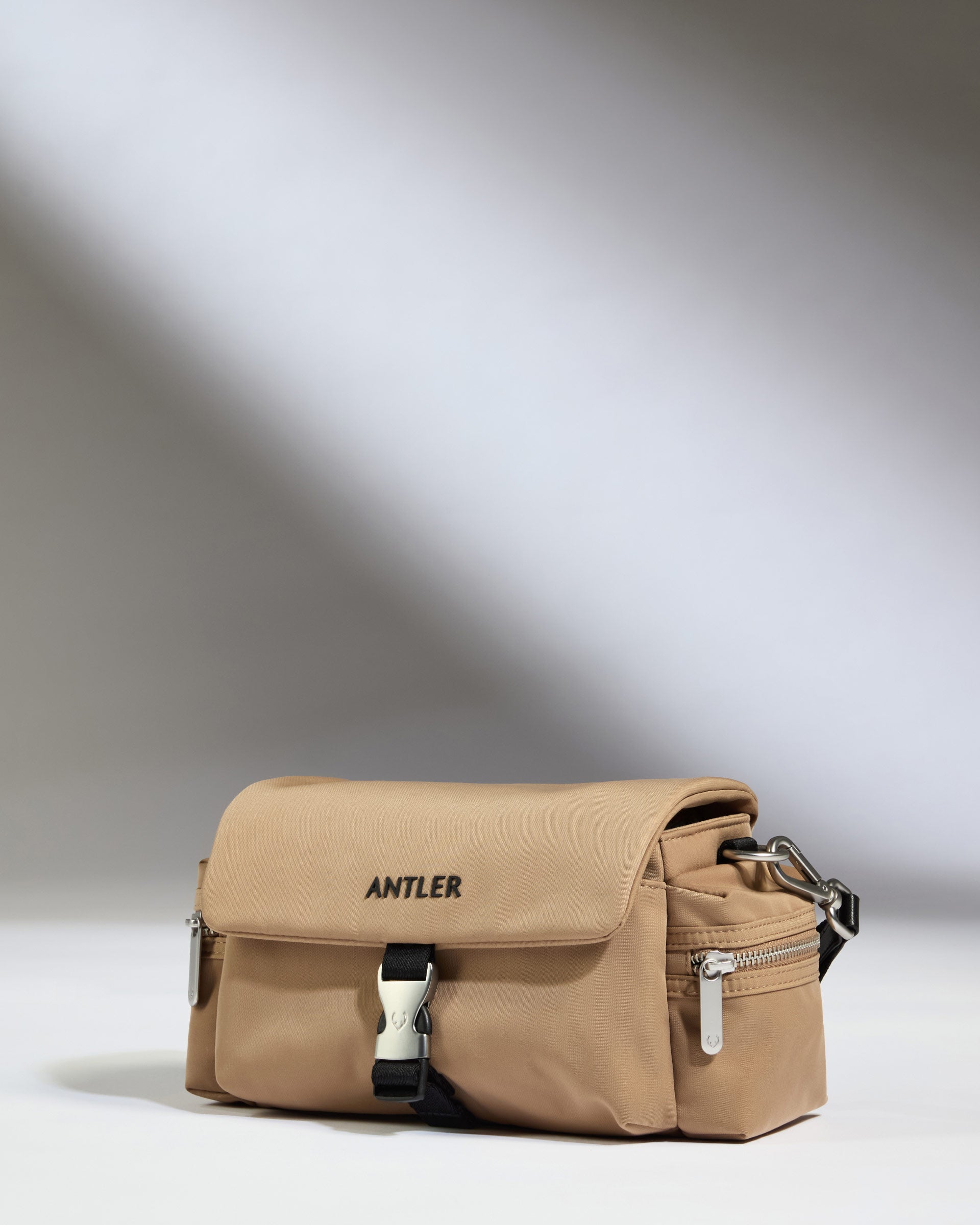 a tan bag with black straps