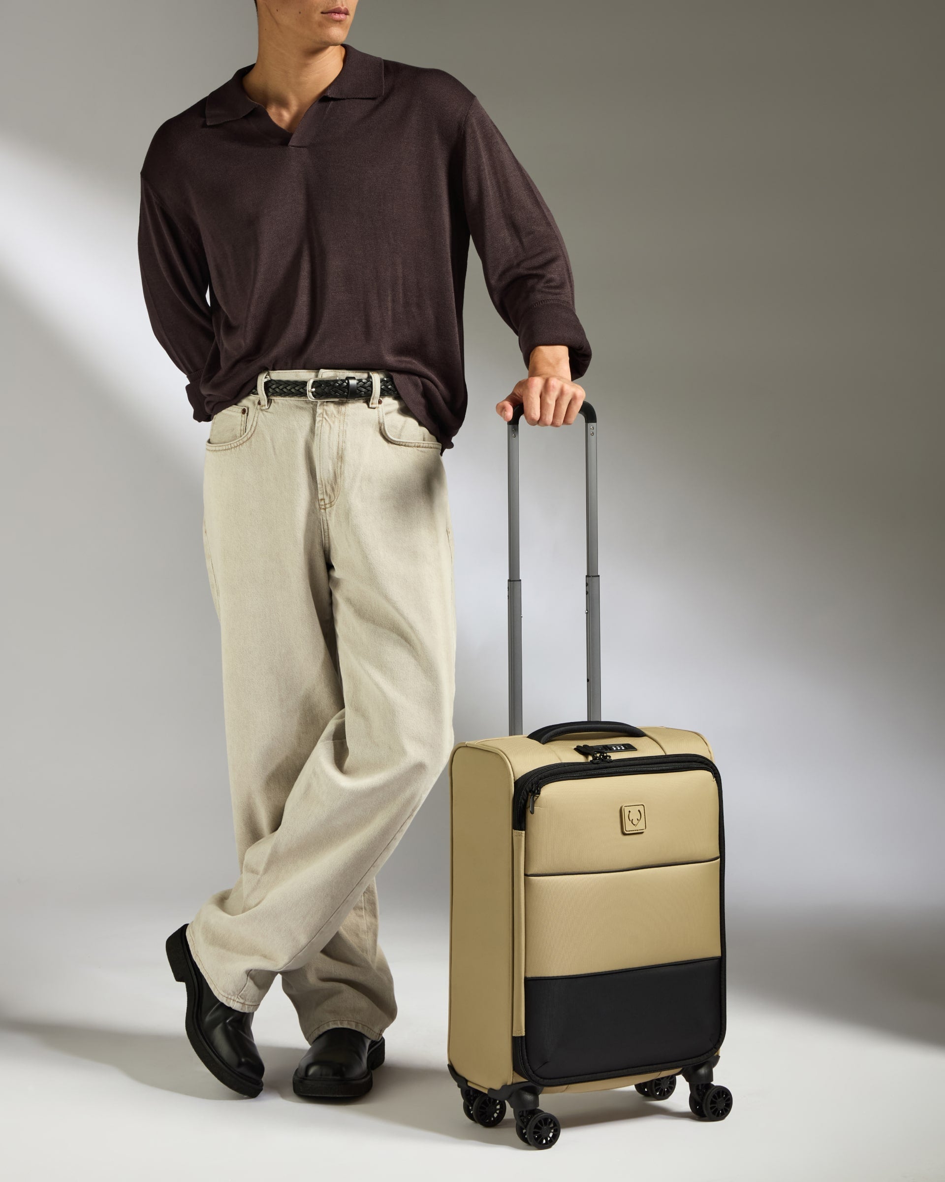 a man standing next to a suitcase