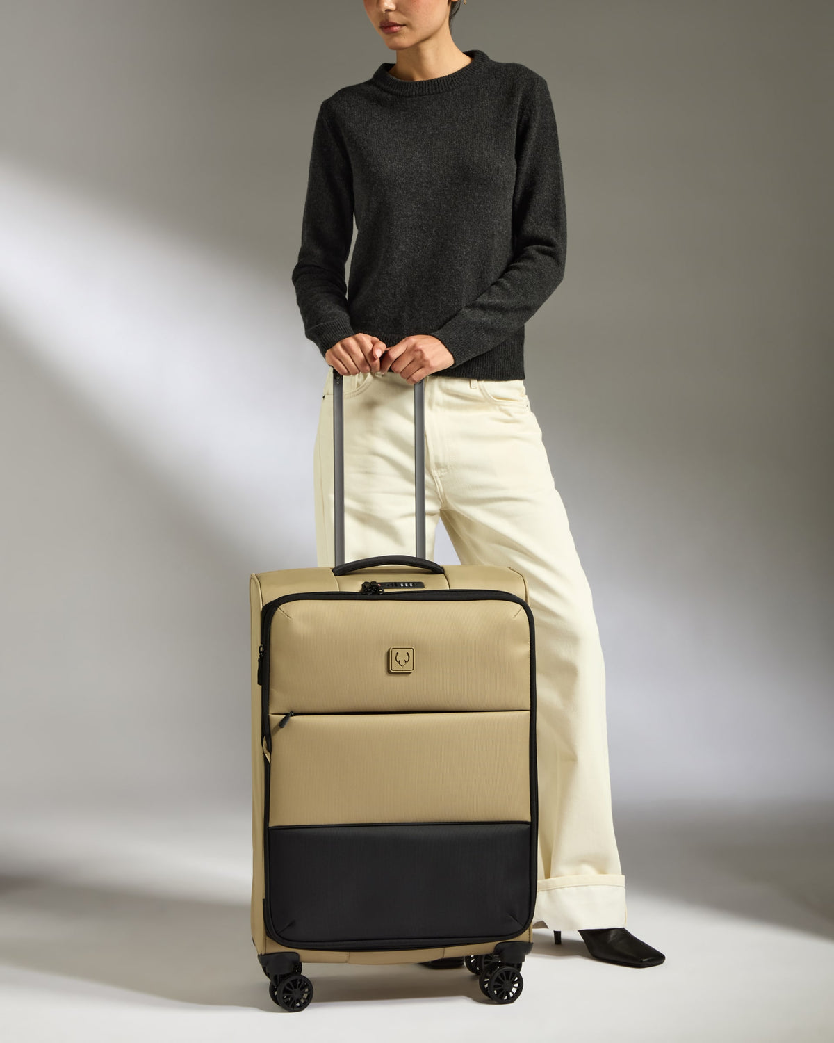 a woman standing with a suitcase