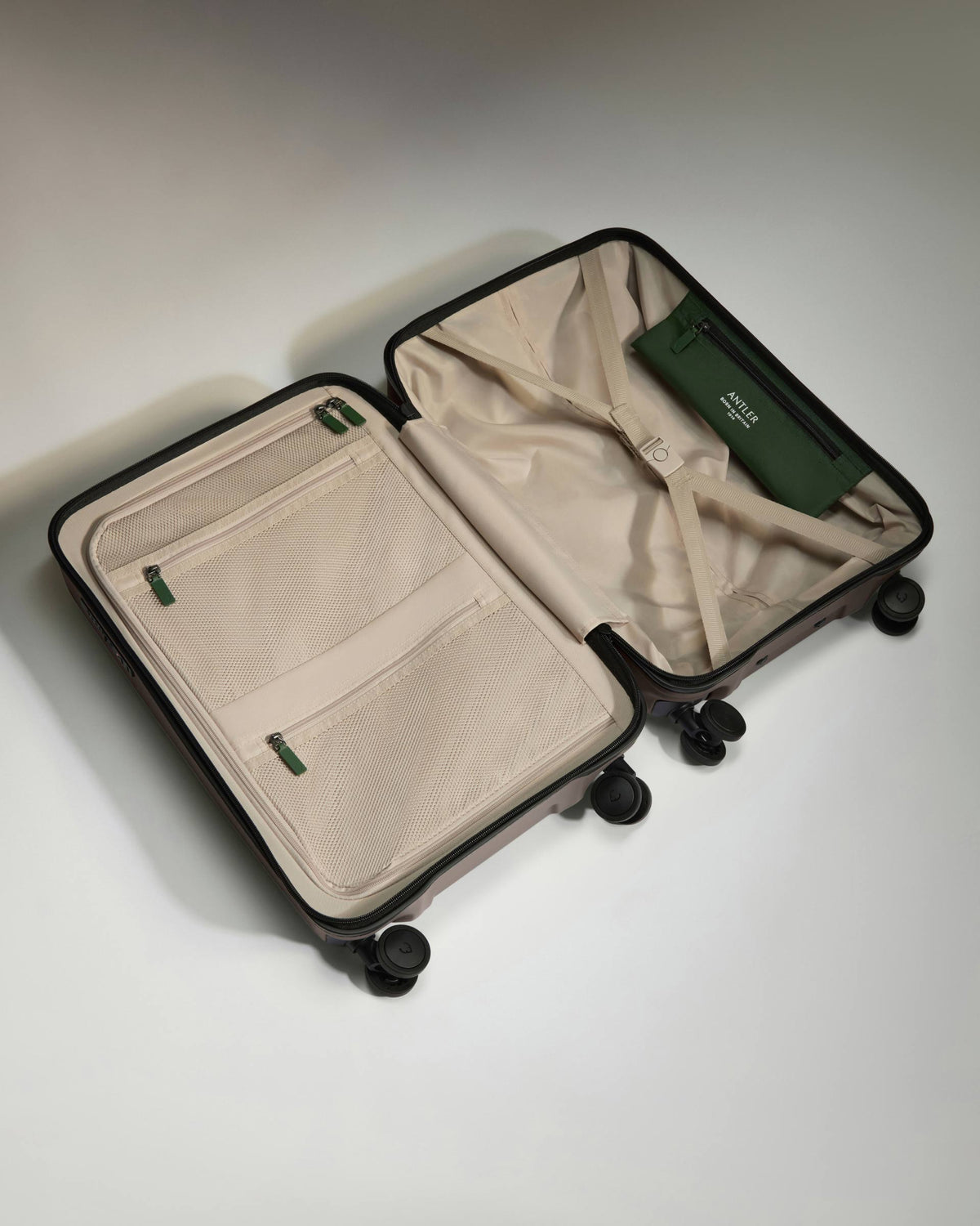 a suitcase with wheels and a green wallet