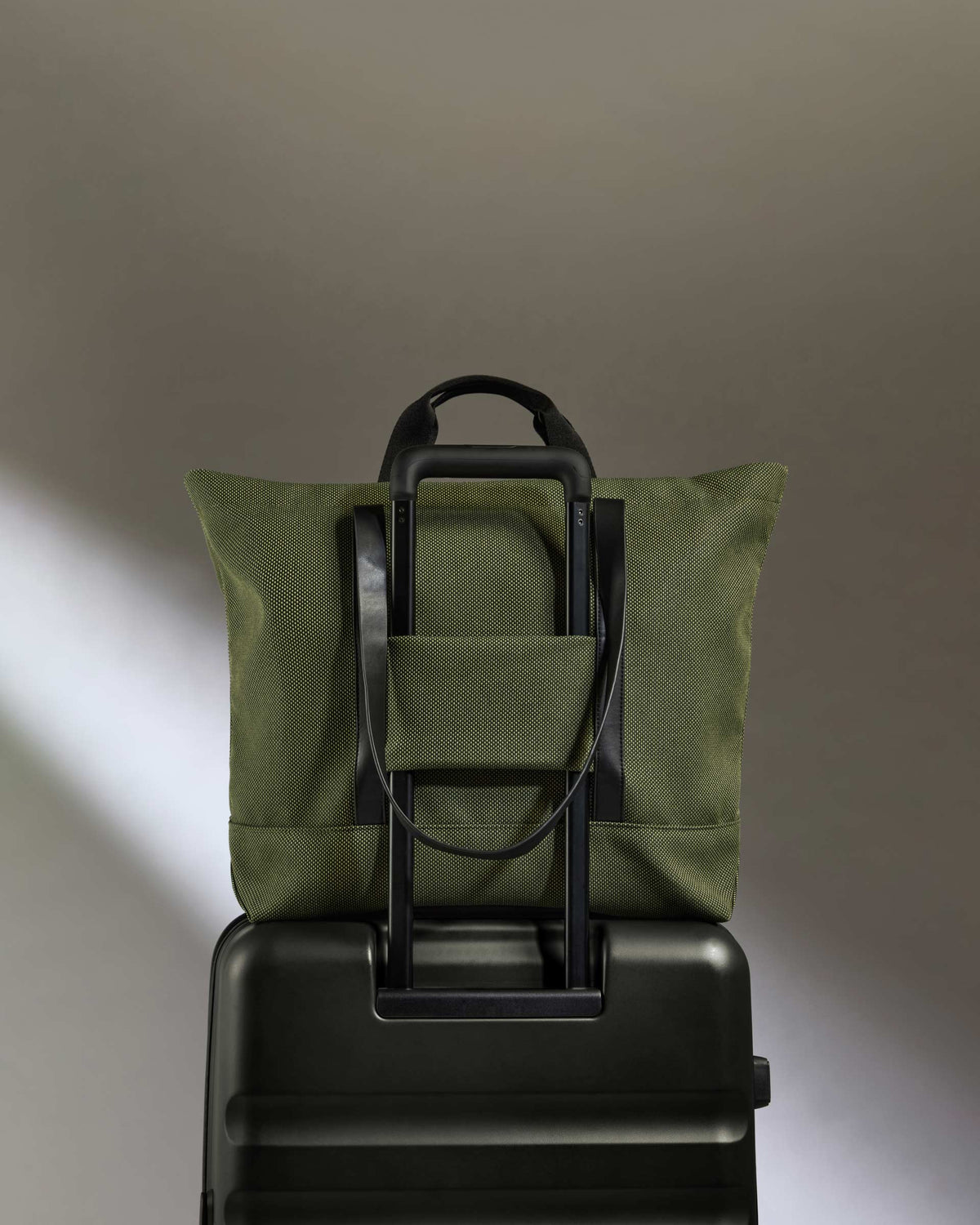 a bag on top of a suitcase
