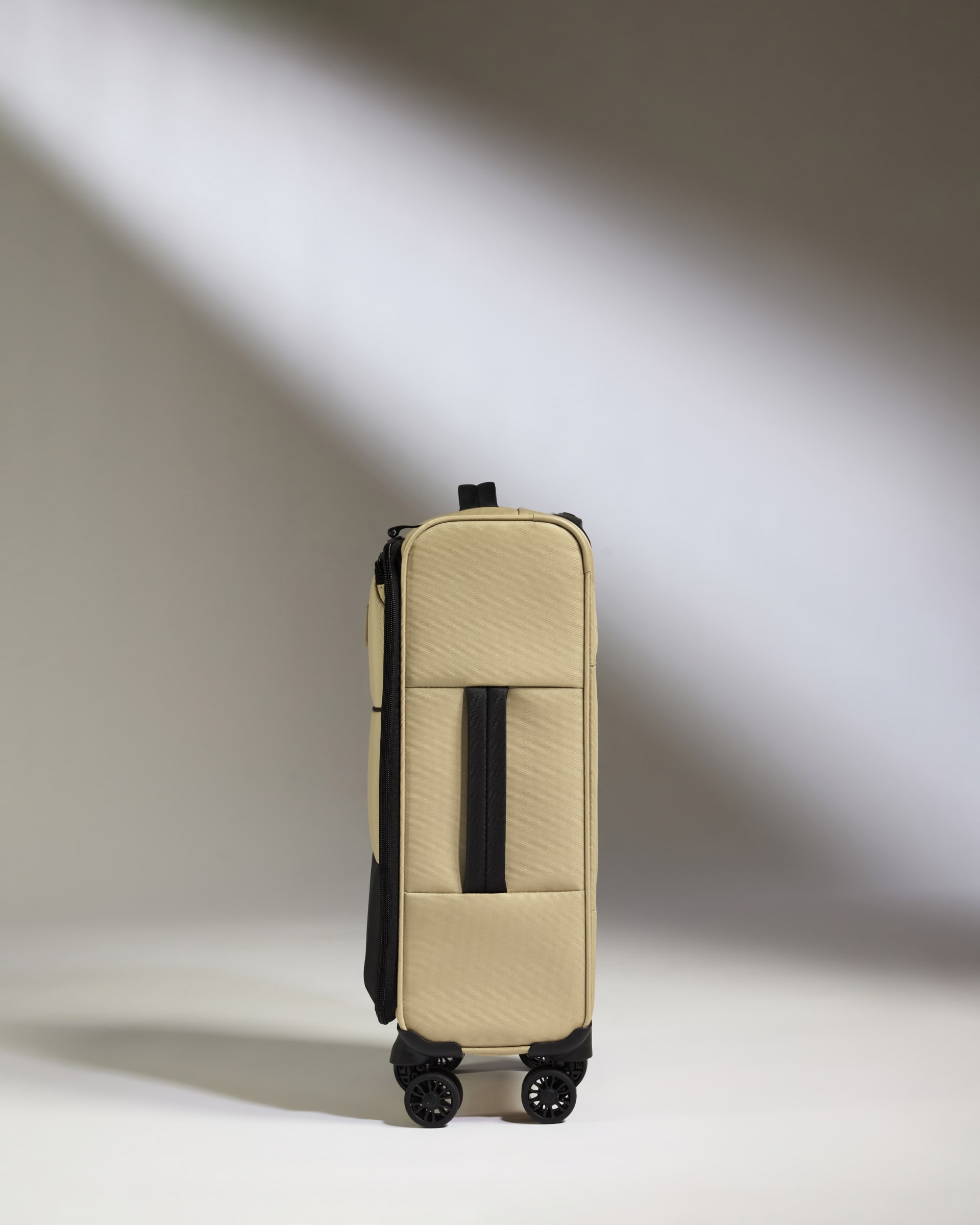 a tan suitcase with wheels