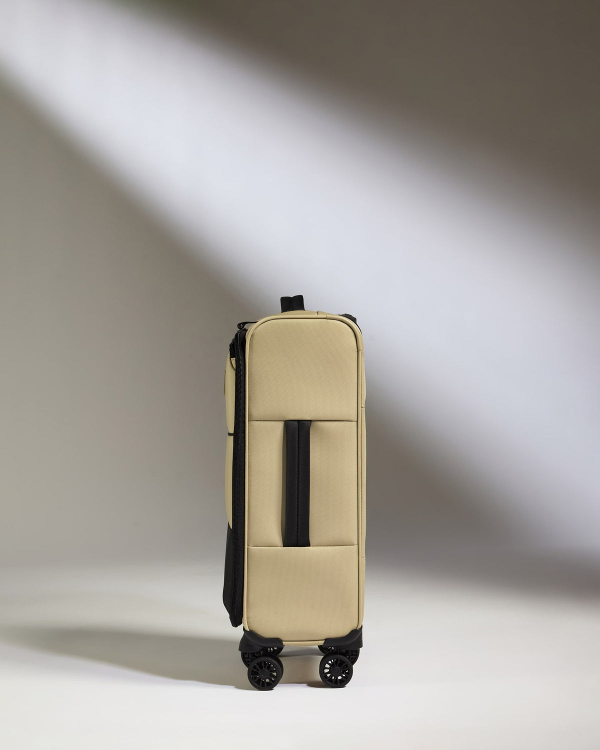 a tan suitcase with wheels