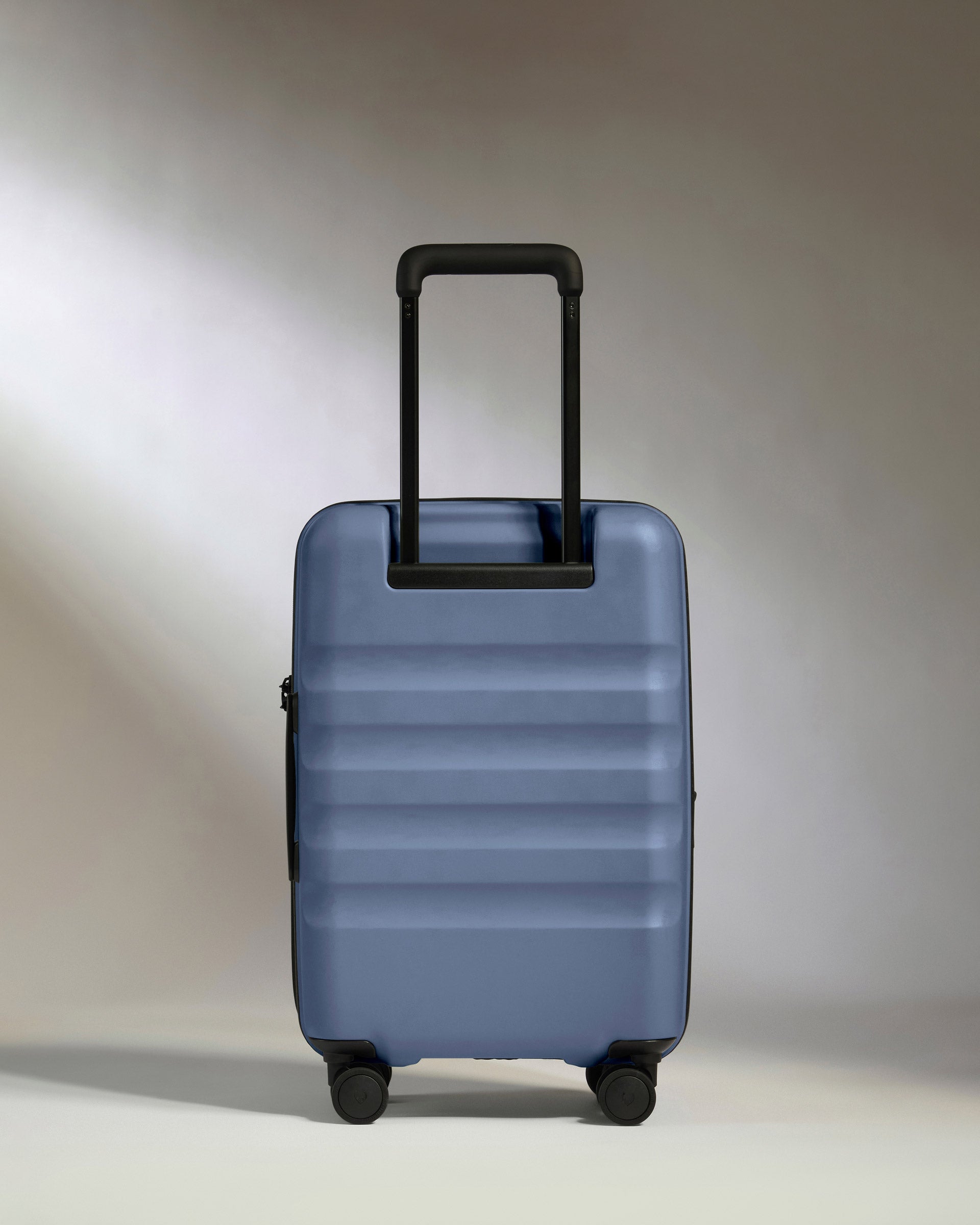 a blue suitcase with black wheels