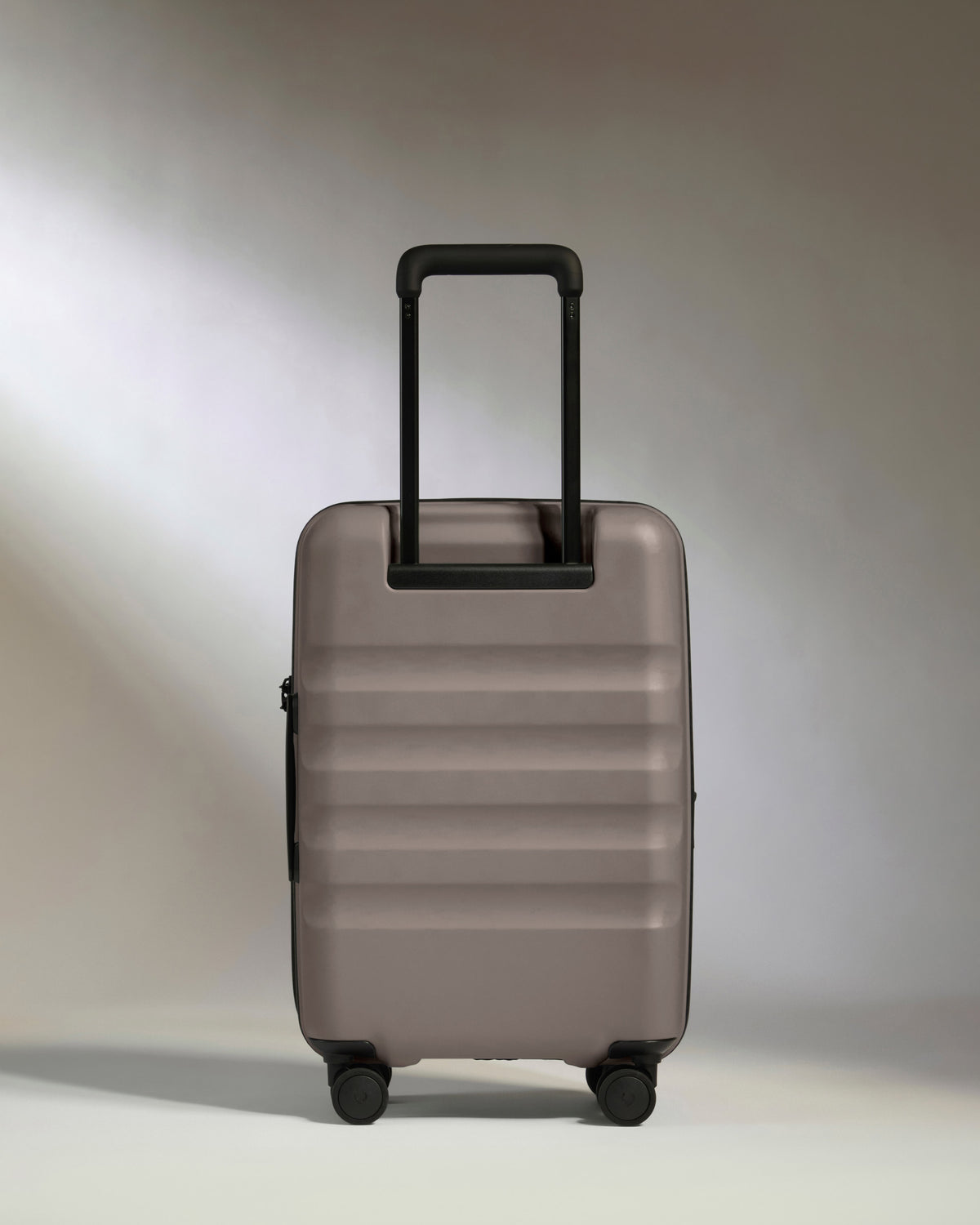 a grey suitcase with black handle